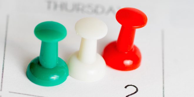 green white red pins on calendar grid medication synchronization