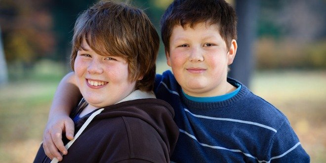 portrait of two cute overweight boys, arms around Friendship: portrait of two cute overweight boys