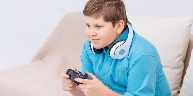 Chubby kid is playing video games Game time.