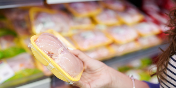 meat in food store . Woman choosing packed fresh chicken meat in supermarket