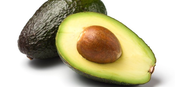 whole and half avocados isolated on white background
